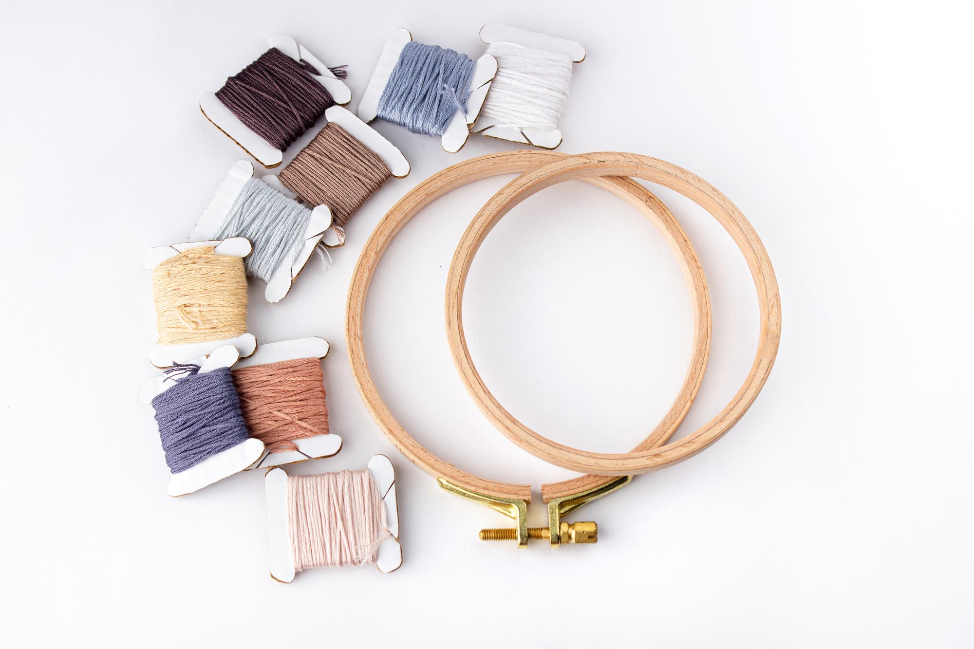 students working on embroidery hoops in a bright studio