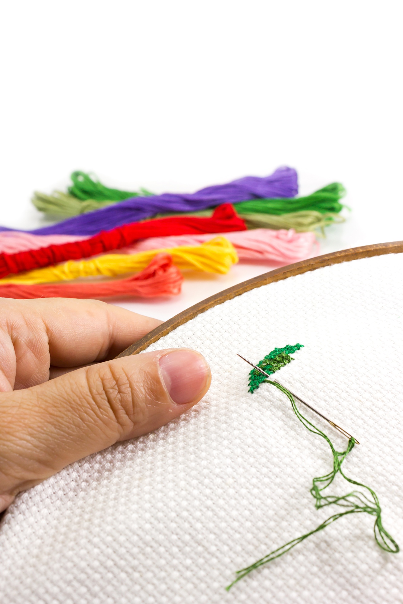 teacher demonstrating hand embroidery close-up